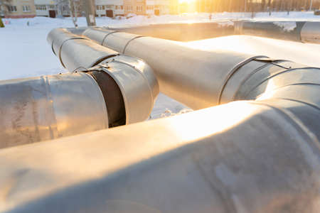 city central heating pipes wrapped with a repair patch made of yellow insulating material in winter in Russiaの写真素材