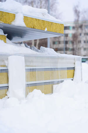 Insulated sandwich panels lie on the ground under the snow. Construction site in Russiaの写真素材