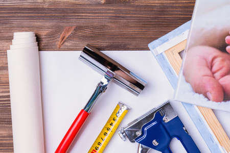 print photos on canvas. A tool for stretching a canvas with a photo on a wooden stretcher. Forceps, stapler for staples and measuring tapeの写真素材