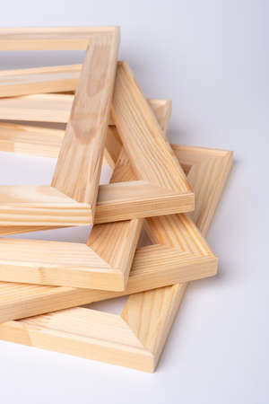 A stack of wooden stretchers for stretching the canvas lies on a white background.