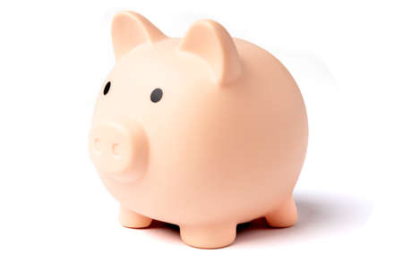 Pink plastic piggy bank isolated on a white background, side viewの写真素材