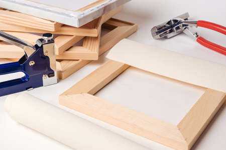 The process of stretching the canvas on a stretcher in the framework shop. Canvas wrapped on a...