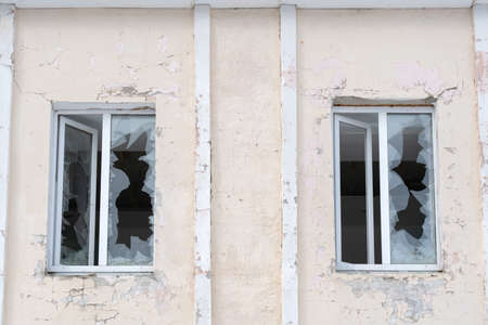 Two plastic windows with broken glassの写真素材