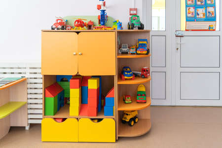 March 09, 2022 Neftekamsk, Russia: The interior of a kindergarten in Russia, toys laid out on the shelves of the cabinetのeditorial素材