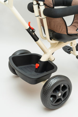 Trunk attached to the back of a children's tricycle close-up, selective focus. vertical photoの写真素材
