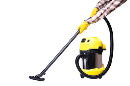 The hands of a man in yellow gloves hold a yellow construction vacuum cleaner, isolate on a white backgroundの写真素材