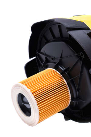air filter on the cover of a yellow construction vacuum cleaner, isolate on a white backgroundの写真素材