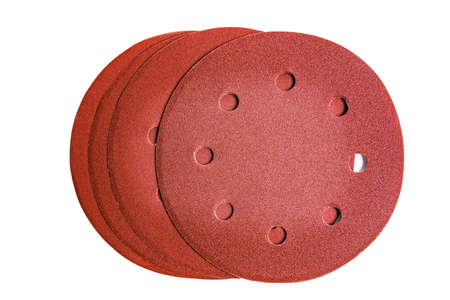 Round emery discs with holes for a grinder with different types of grit, isolated on a white background.の写真素材