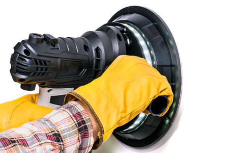 Worker holding a wall sanding machineの写真素材