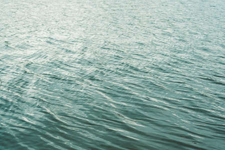 Waves on river water during sunset