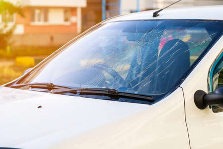 broken windshield of a car on a city streetの写真素材