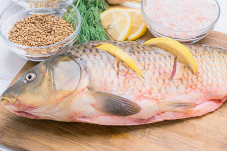 Preparation of carp stuffed with lemon slicesの写真素材