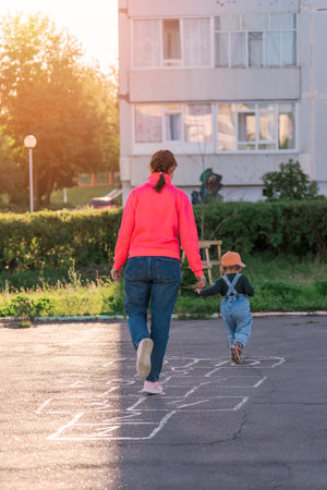 Mom and baby play hopscotch on the playgroundの写真素材