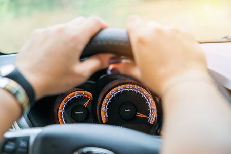 Car speedometer and female hands, selective focusの写真素材
