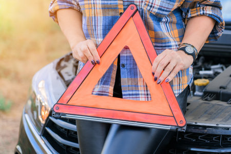 A woman holds an emergency stop sign in her hands, close-upの写真素材