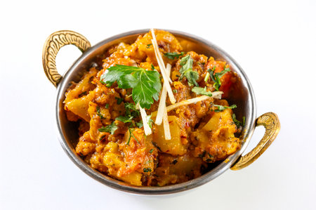 Aloo Gobi Masala traditional Indian cuisine dish with fresh cauliflower, potatoes, cooked in onion sauce and tomato with spices seen up close and isolated on a white backgroundの写真素材