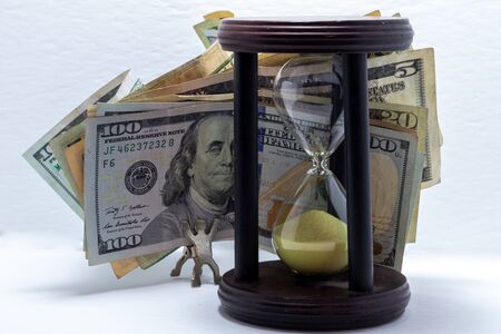 Sand timer. Race against time productivity, money, success. Hourglass and money. carrying USD bills. Accomplishment concept, Competing against time.の写真素材