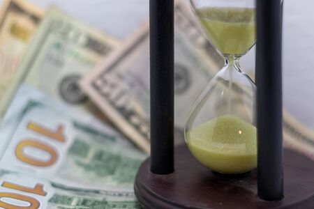 Competing against time, Race against time productivity, money, success. Hourglass and money. Sand...