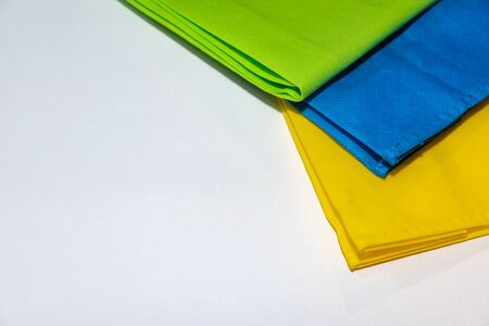 Ecological Bag in three colors, green, blue and yellow. recicle concept. text space.