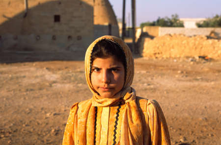 Unidentified young girl with her traditional dressing and colorful scarf, outskirts of Hama, Syriaのeditorial素材