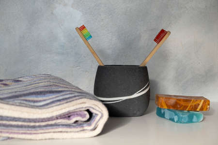 sustainable lifestyle concept. eco natural bamboo toothbrush, natural soap, towel. bathroom...