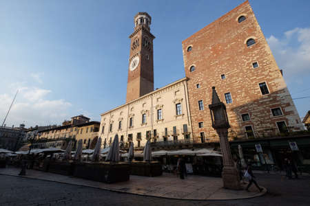 Veneto Region, Northern Italy: Piazza Delle Erbe square Torre dei Lamberti clock tower in city center Citta Antica. Palazzo Della Ragione palace building in Piazza Delle Erbe square in Verona city.のeditorial素材