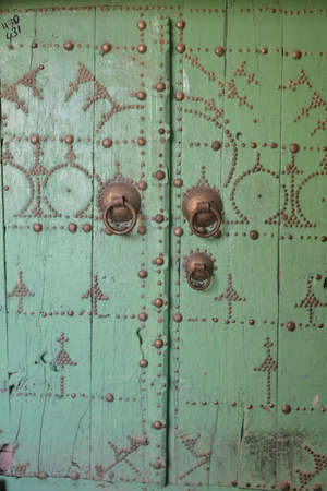 Door of the Medina quarter in Tozeur Ouled el Hadef in the Sahara desert near Tozeur, Tunisia, Africa. Decorated with patterns and ornaments. The historical medina.の写真素材