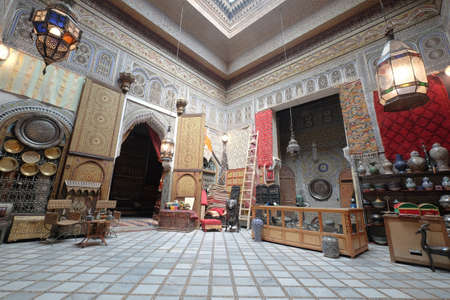 Interior of a room in Fes Morocco. Traditional oriental interior design with featured arches, geometric designs, two big chandeliers and decorative tilework.のeditorial素材