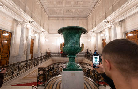 Tourist taking a picture of the large malachite vase places at the Soviet Staircase in Great Hermitage museum Winter palace. An elegant staircase is located between 4 different parts of the museum.のeditorial素材