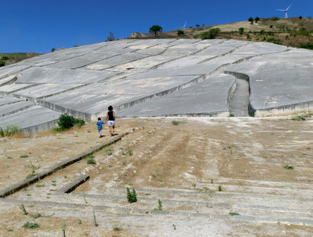 mother and son visit the cretto by artist Alberto Burri, old Gibellina, Sicily, Italyのeditorial素材