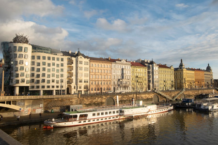 Panorama of dancing house and boats on the Vltava river in the capital of the Czechia, Prague. Europeのeditorial素材