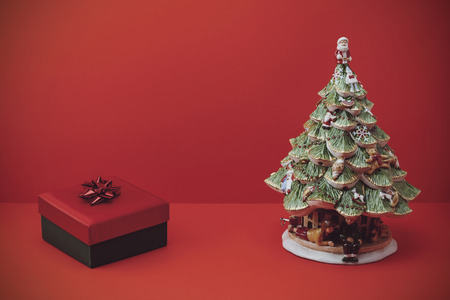 vintage christmas gift and tree on red backgroundの写真素材