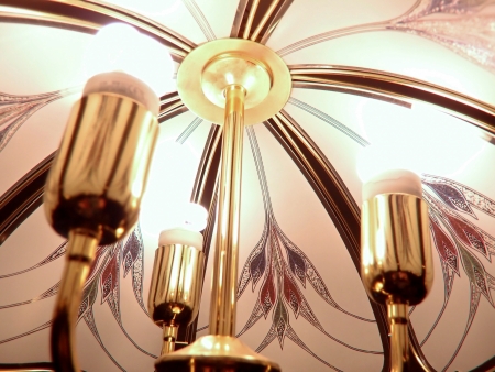 chandelier from the ceiling,with three bulbs lit,seen from below,closelyの写真素材
