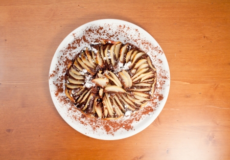 Chocolate and pear cake, made with pear slices aligned all around in the top and sugar on top.の写真素材