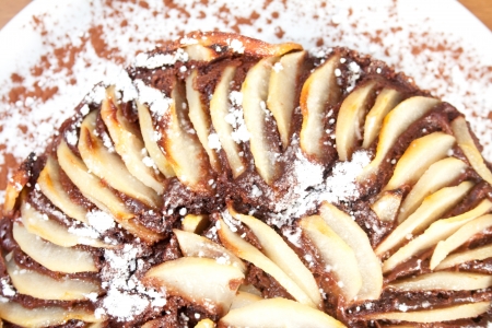 Chocolate and pear cake, made with pear slices aligned all around in the top and sugar on top.の写真素材