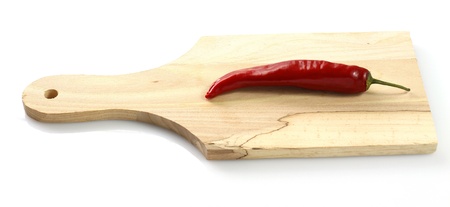 Hot pepper on wooden chopping boardの写真素材