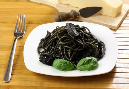 Pasta with squid ink on wooden tableの写真素材