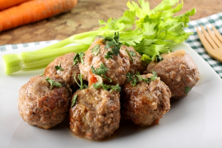 Meatballs stewed with vegetables on complex backgroundの写真素材