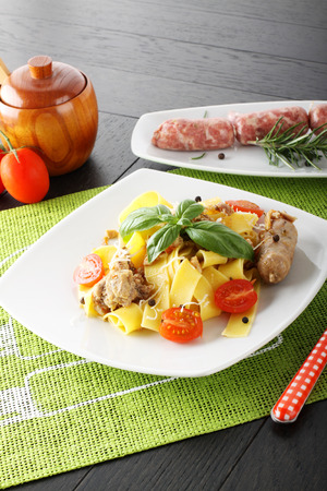 Pasta with sausage ragout and parmesan on complex backgroundの写真素材