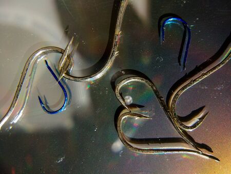 groups of fishing hooks on a metallic backgroundの写真素材