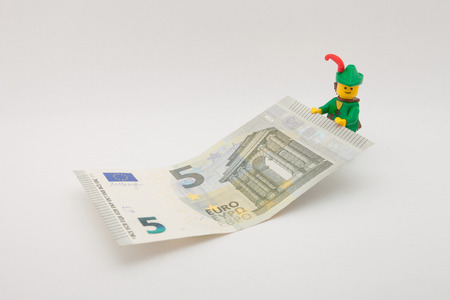 Venice, Italy - November 27 - 2014: Robin Hood (as Lego figure) keeping a 5 euro billのeditorial素材