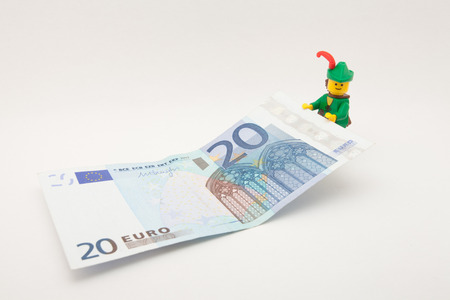 Venice, Italy - November 27 - 2014: Robin Hood (as Lego figure) keeping a 20 euro billのeditorial素材