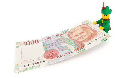 Venice, Italy - November 27, 2014: Robin Hood (as Lego figure) keeping an old Italian 1000 Lire bill, November 27, 2014 in Venice, Italyのeditorial素材