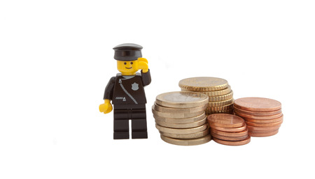 Venice, Italy - December 27, 2014 - A policeman (as Lego figures) standing next to European euro coinsのeditorial素材