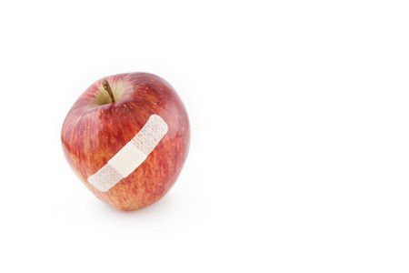 Isolated damaged red apple on white backgroundの写真素材