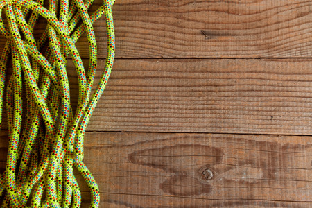 Yellow mountain rope on wooden background