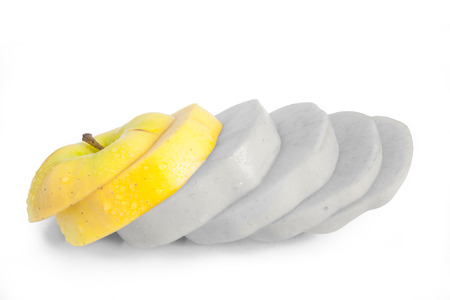 Single yellow apple cut into diagonal slicesの写真素材