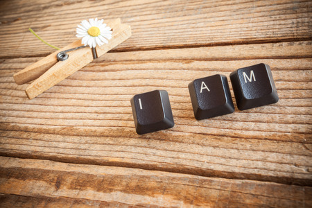 "I am" wrote with keyboard keys on wooden backgroundの写真素材