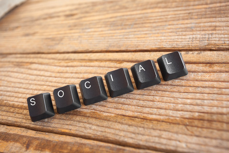 social wrote with keyboard keys on wooden background