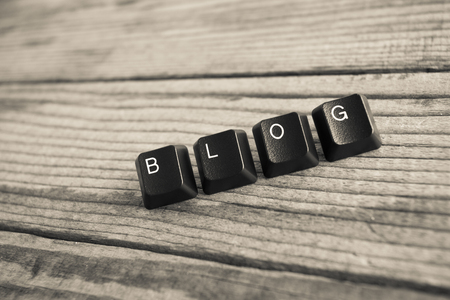 BLOG wrote with keyboard keys on wooden background, black and white effectの写真素材